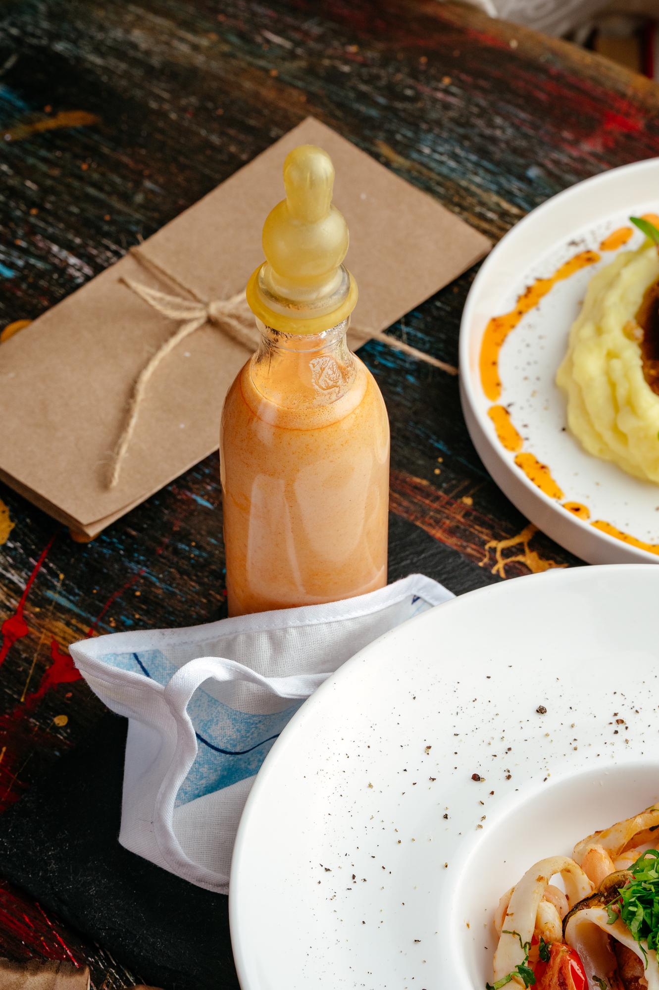 Packaged sauce product staged on table